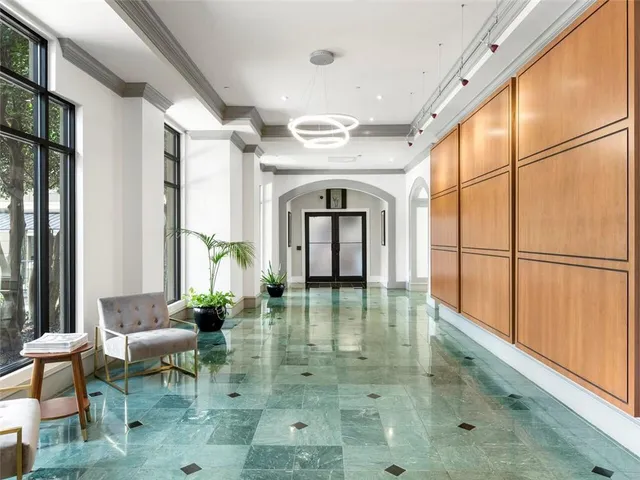 a view of an entryway with a floor to ceiling window and wooden floor