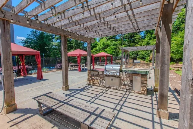 a view of a patio with a table and chairs under an umbrella