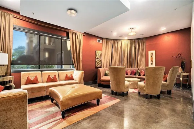 a living room with furniture and large window