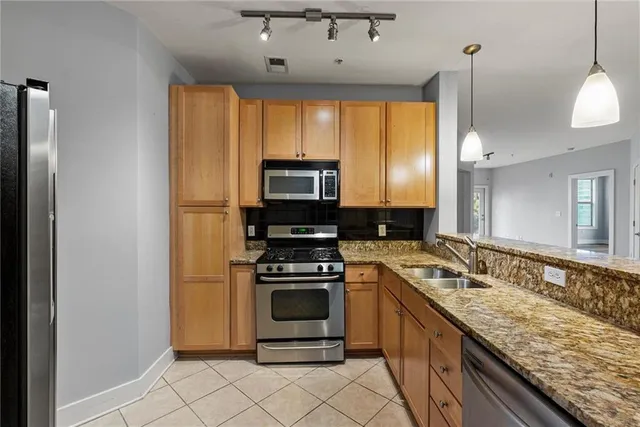 a kitchen with a sink stove and refrigerator