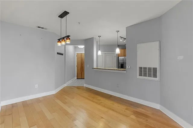 a view of a kitchen with a refrigerator and a window