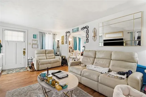 a living room with furniture a rug and a flat screen tv