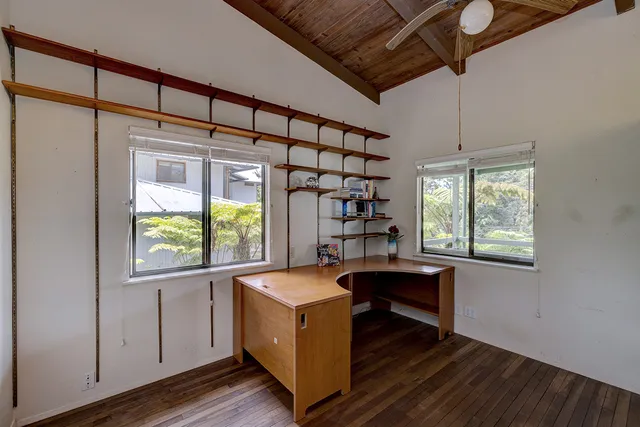 a room with a wooden floor and a window