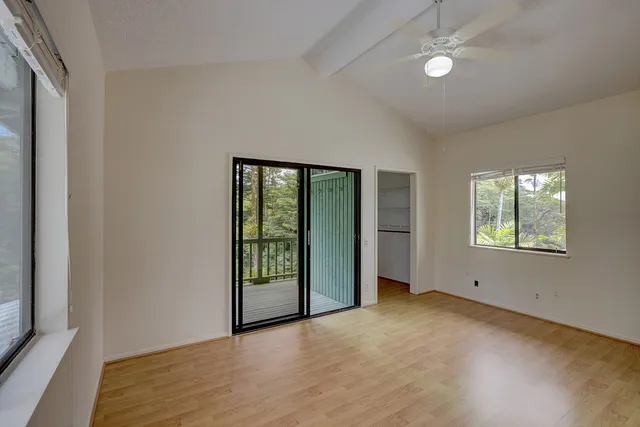 an empty room with windows and closet