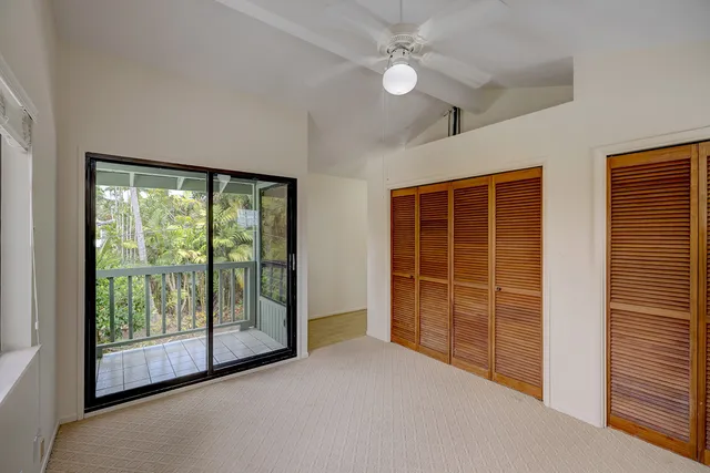 an empty room with windows and closet