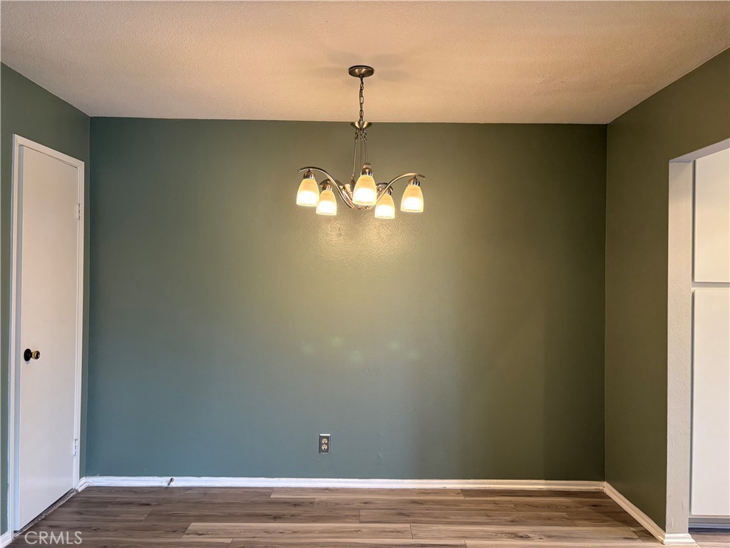 70 Echo Run, Unit 31 Irvine, CA 92614 - Photo 4 of 19 a view of empty room with window and wooden floor