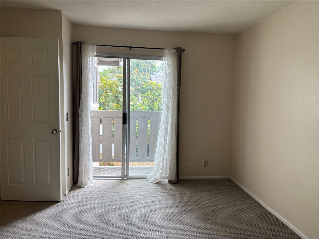 70 Echo Run, Unit 31 Irvine, CA 92614 - Photo 8 of 19 an empty room with sliding door