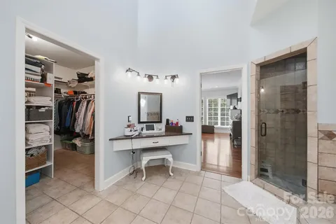 a room with a walk in closet and a bathroom