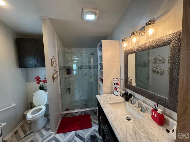 a bathroom with a sink toilet and shower