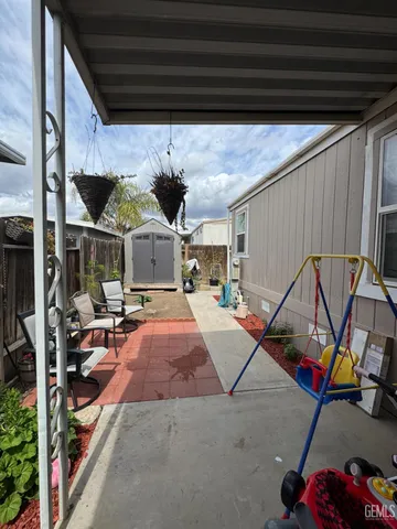 a backyard of a house with table and chairs