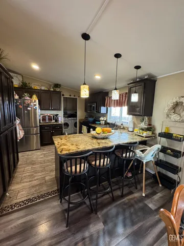 a large kitchen with a table and chairs