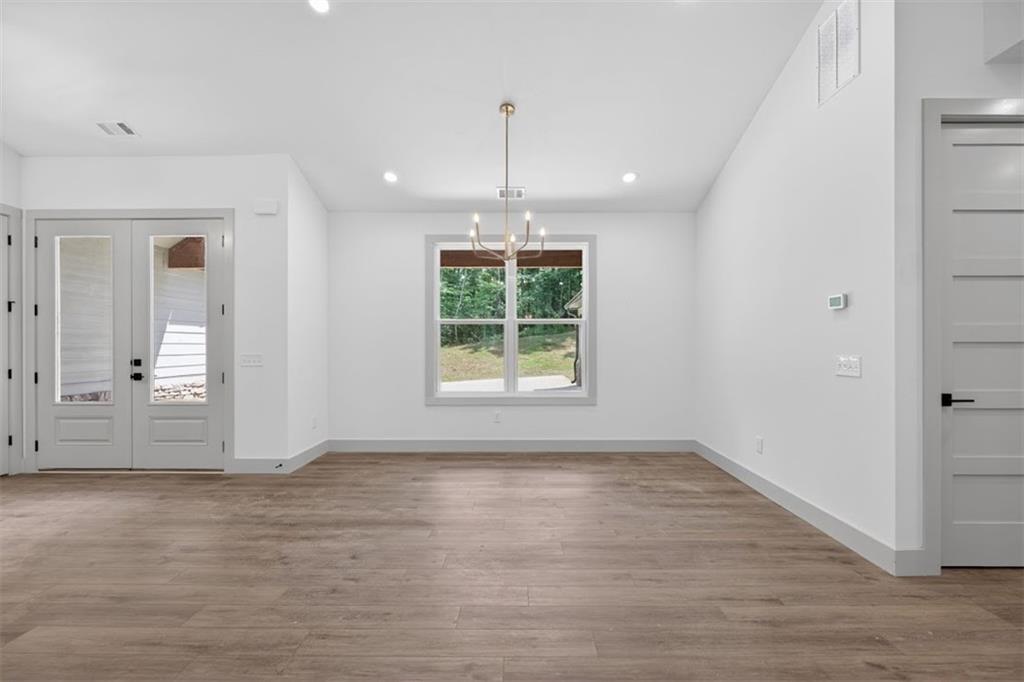1416 Morgan Road Bremen, GA 30110 - Photo 14 of 32 a view of an empty room with wooden floor and a window