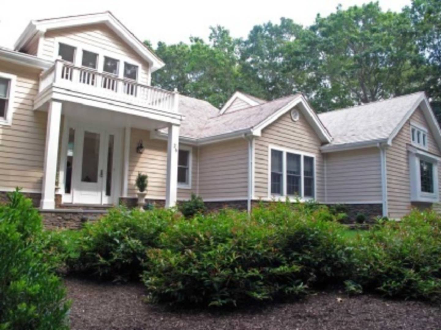 26 Cedar Trail East Hampton, NY 11937 - Photo 16 of 16 a view of a white house next to a yard with plants and trees