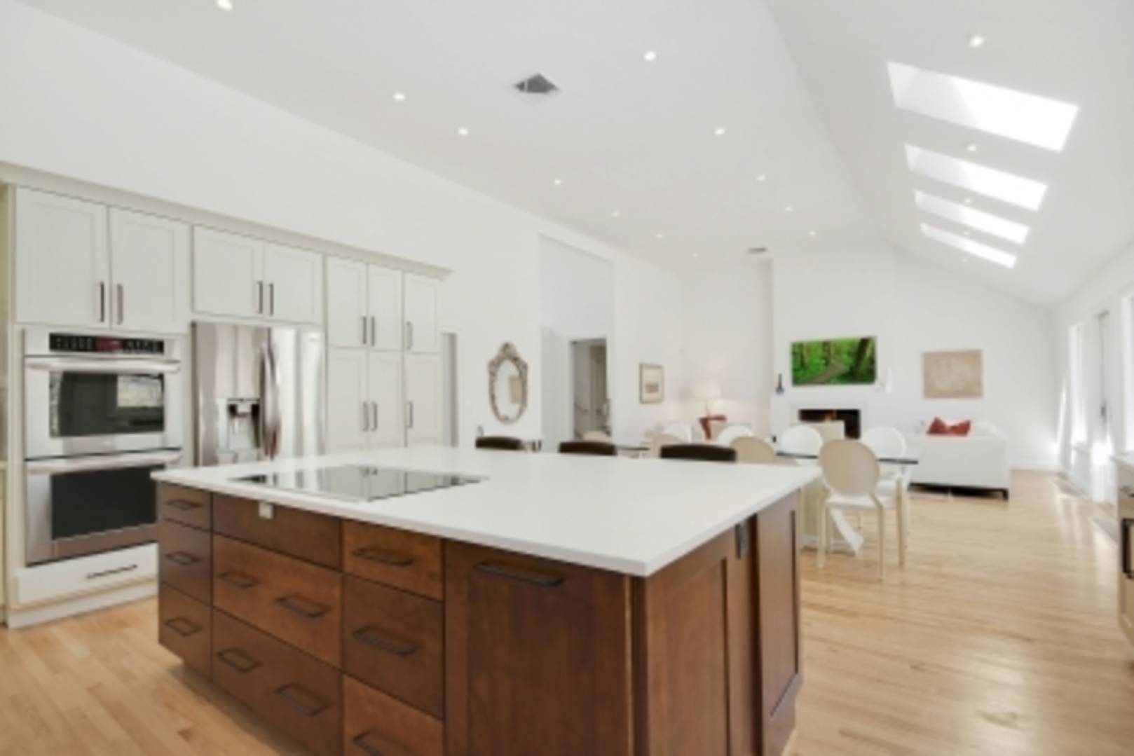 26 Cedar Trail East Hampton, NY 11937 - Photo 3 of 16 a view of kitchen island a sink wooden floor and living room view