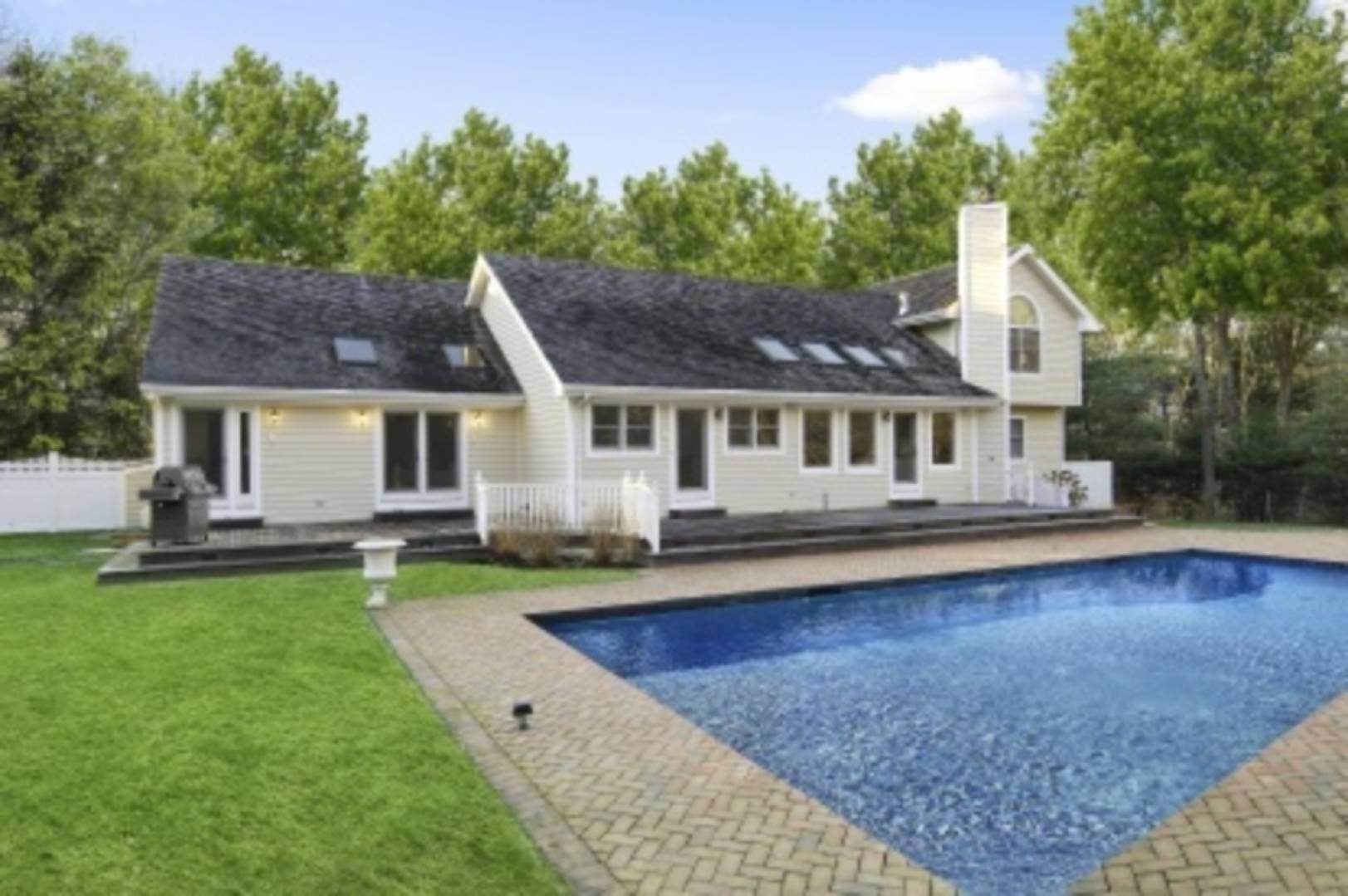 26 Cedar Trail East Hampton, NY 11937 - Photo 5 of 16 a front view of a house with swimming pool having outdoor seating