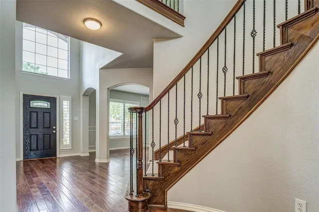 a view of an entryway with wooden floor and door