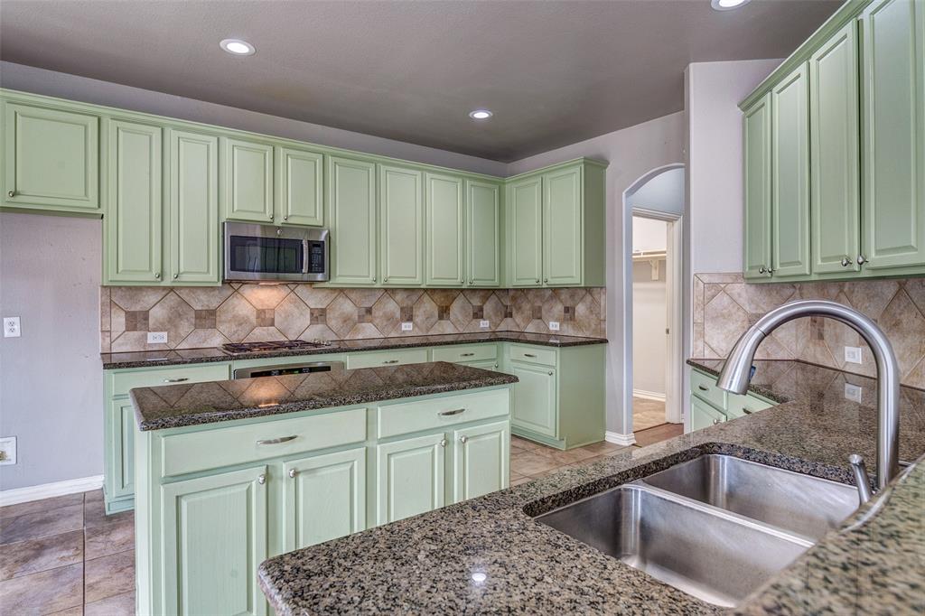 916 Carlsbad Drive Allen, TX 75002 - Photo 11 of 34 a kitchen with a sink stove and cabinets