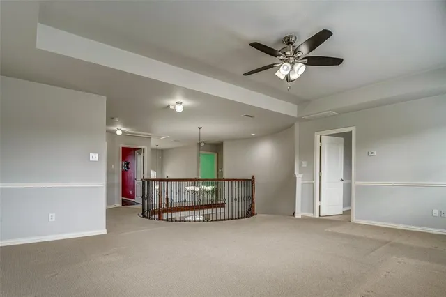 a view of an empty room with a ceiling fan