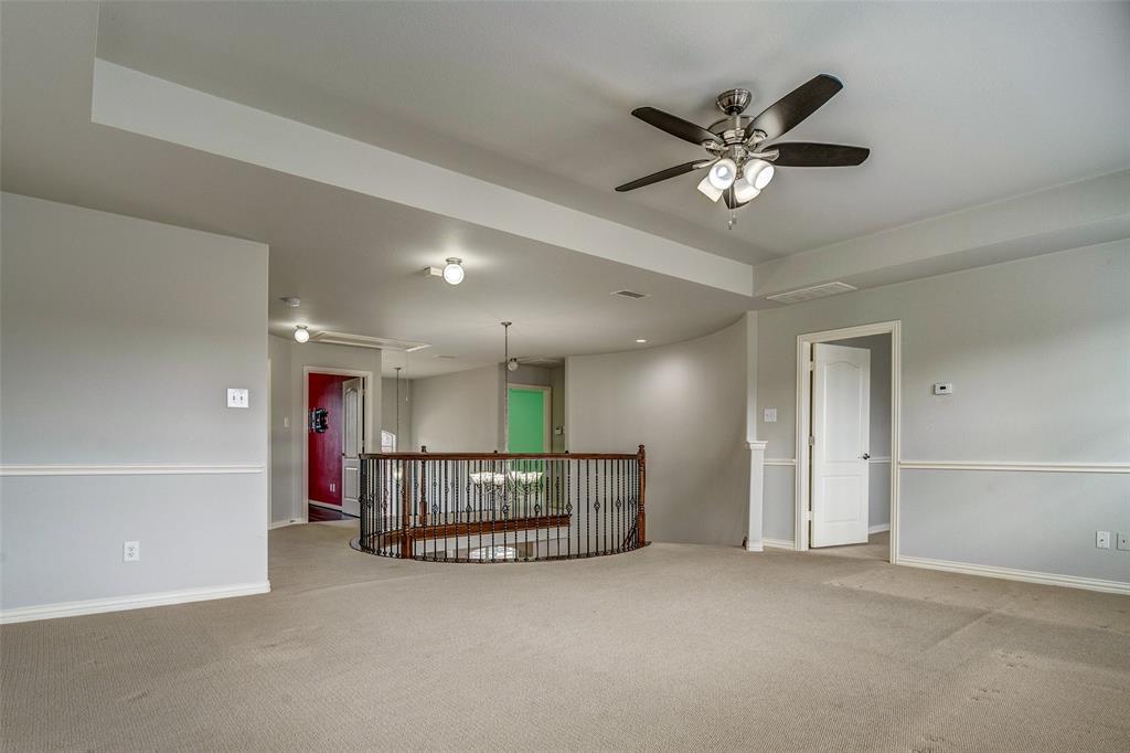 916 Carlsbad Drive Allen, TX 75002 - Photo 21 of 34 a view of an empty room with a ceiling fan