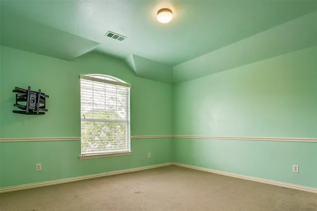 a room with a window and a fan