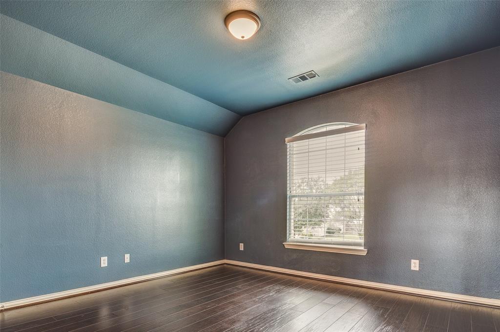 916 Carlsbad Drive Allen, TX 75002 - Photo 31 of 34 an empty room with wooden floor and windows