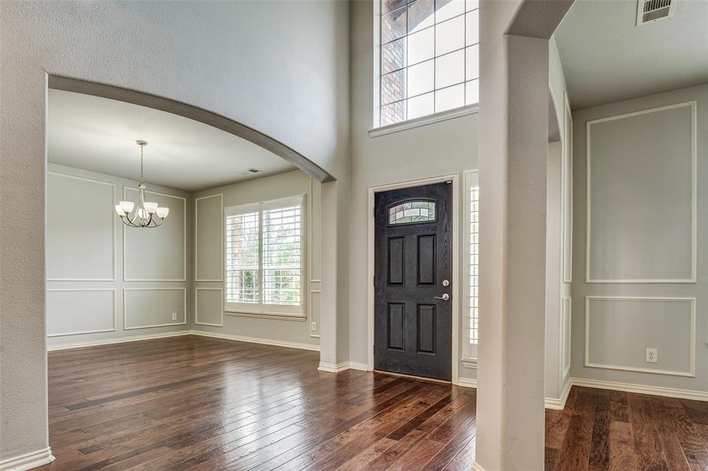 916 Carlsbad Drive Allen, TX 75002 - Photo 5 of 34 an empty room with wooden floor cabinet and windows