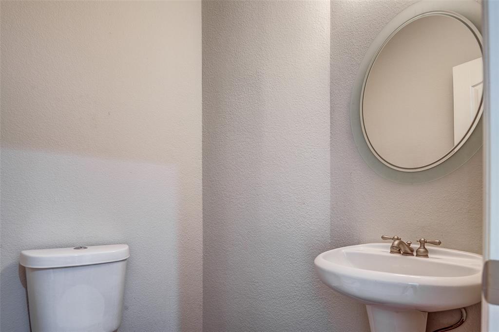 916 Carlsbad Drive Allen, TX 75002 - Photo 6 of 34 a bathroom with a sink a mirror and a toilet