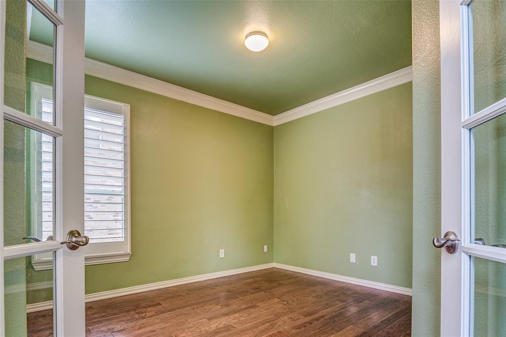 916 Carlsbad Drive Allen, TX 75002 - Photo 7 of 34 a view of empty room with wooden floor and fan