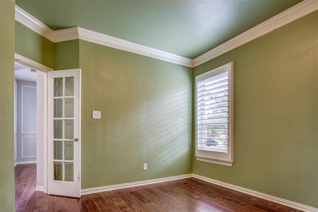 916 Carlsbad Drive Allen, TX 75002 - Photo 8 of 34 an empty room with wooden floor and windows