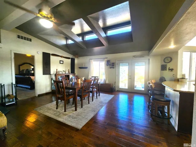 a dining room with furniture and wooden floor