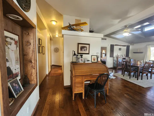 a spacious bedroom with a bed a couch and a chandelier