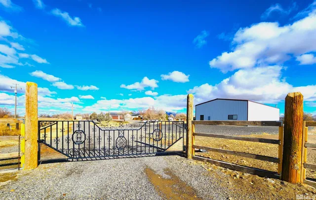 a view of a balcony with a floor to ceiling window next to a yard