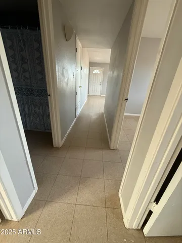 a view of a livingroom with a ceiling fan and window