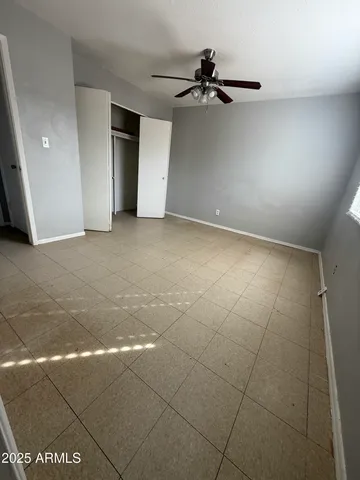 a white toilet sitting next to a bathroom sink and a mirror