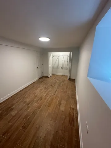 a view of hallway with wooden floor