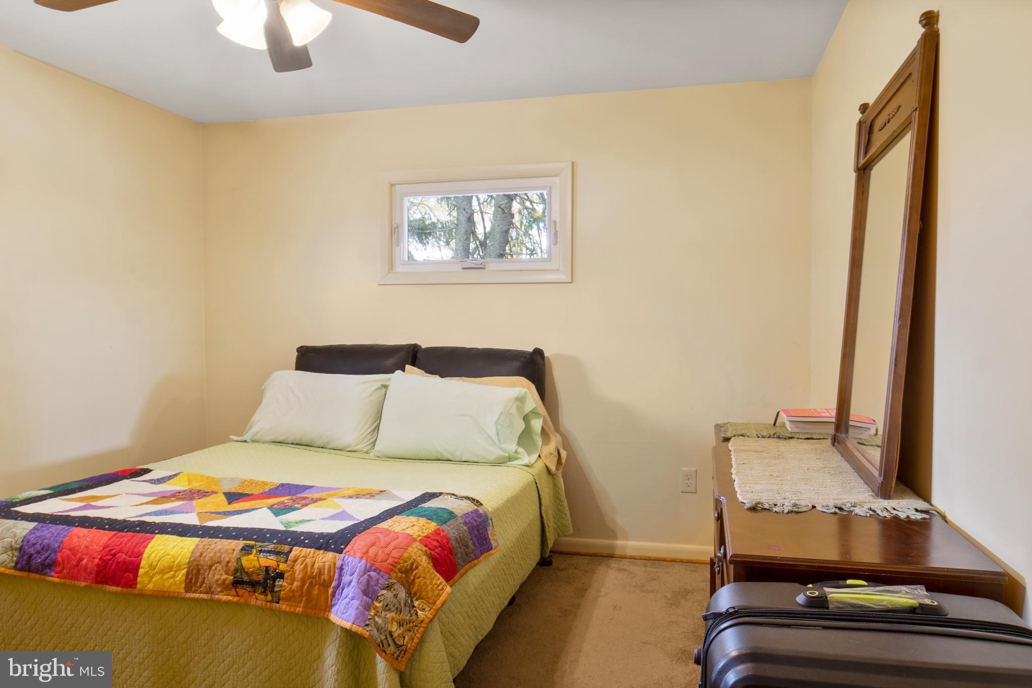 12323 Lanham Severn Road Bowie, MD 20720 - Photo 11 of 20 a bedroom with a bed and a chandelier