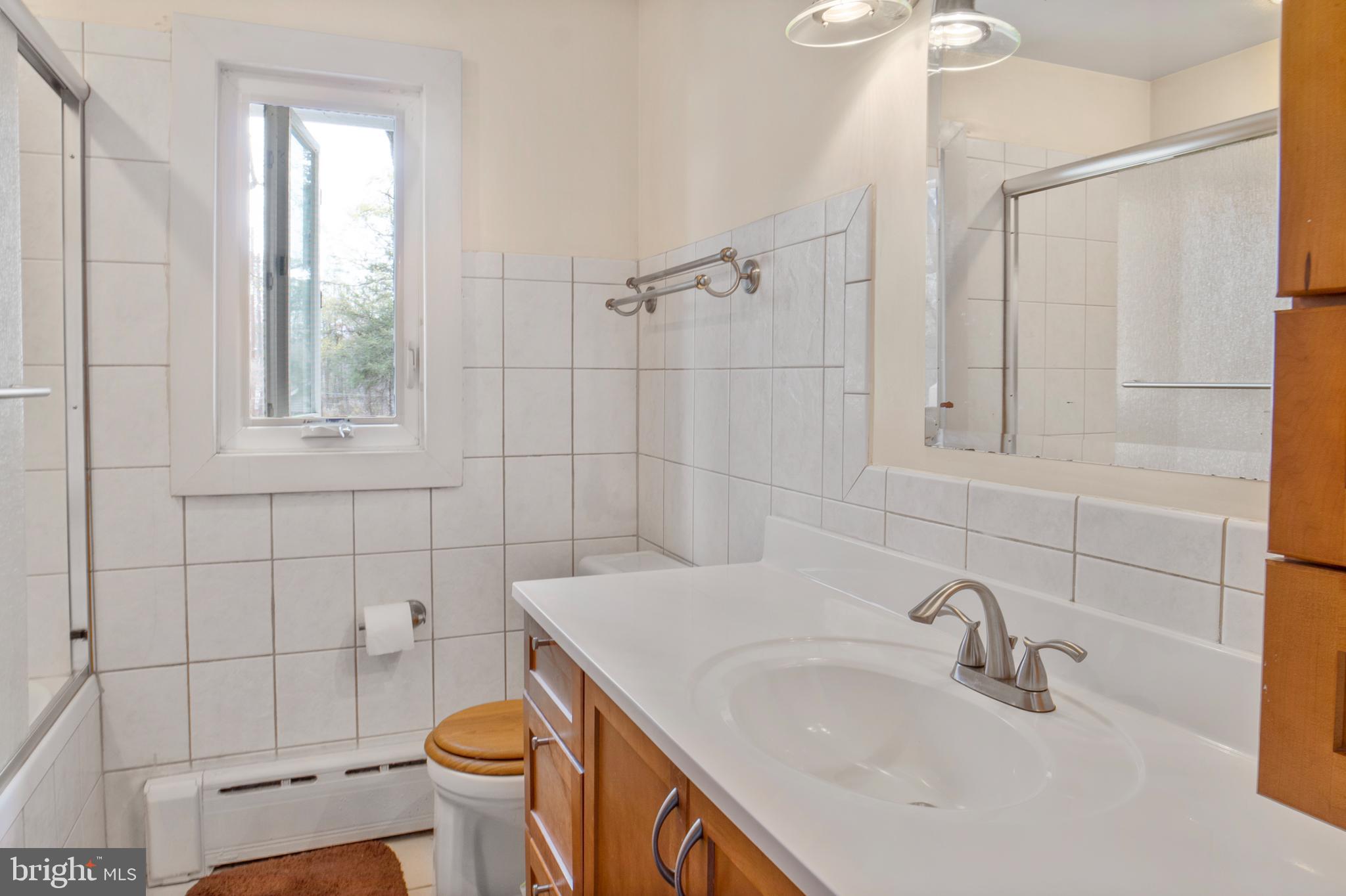 12323 Lanham Severn Road Bowie, MD 20720 - Photo 13 of 20 a bathroom with a sink a toilet and shower