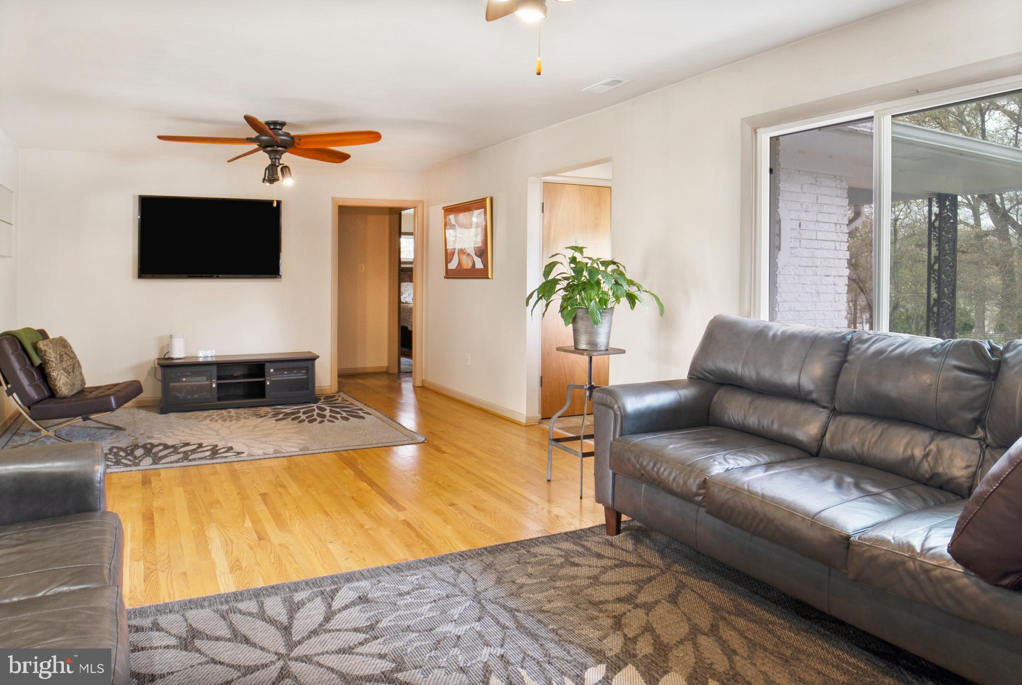 12323 Lanham Severn Road Bowie, MD 20720 - Photo 5 of 20 a living room with furniture and a flat screen tv