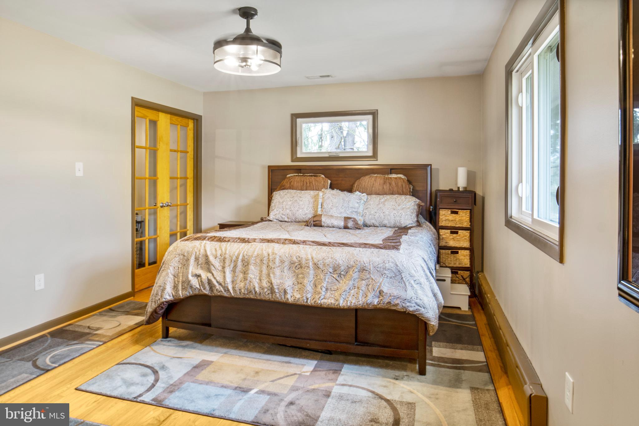 12323 Lanham Severn Road Bowie, MD 20720 - Photo 10 of 20 a bedroom with a bed lamp and a window