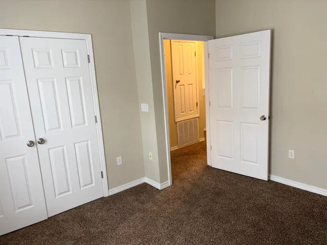 a view of brick house with a table and chairs