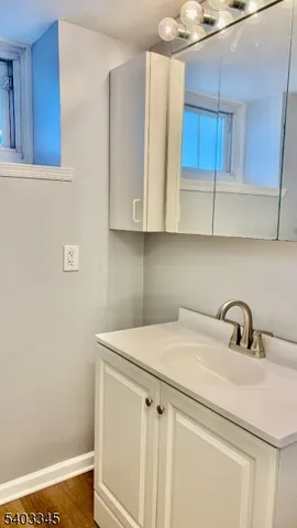 a view of a kitchen with sink and cabinets