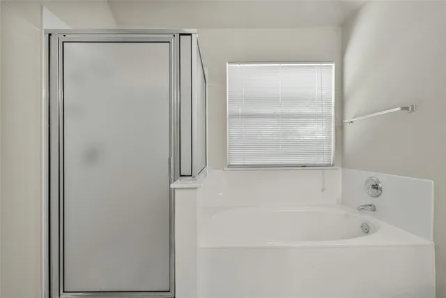a white bath tub sitting next to a window