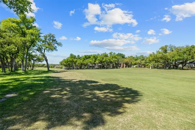 a view of yard with swimming pool and green space