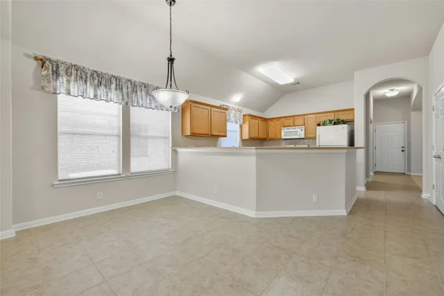 a kitchen with stainless steel appliances granite countertop cabinets and window