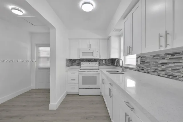 a kitchen with a sink cabinets and appliances