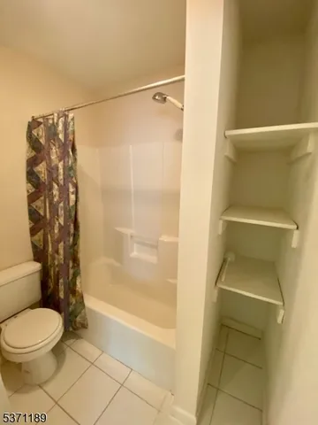 a bathroom with a toilet and shower