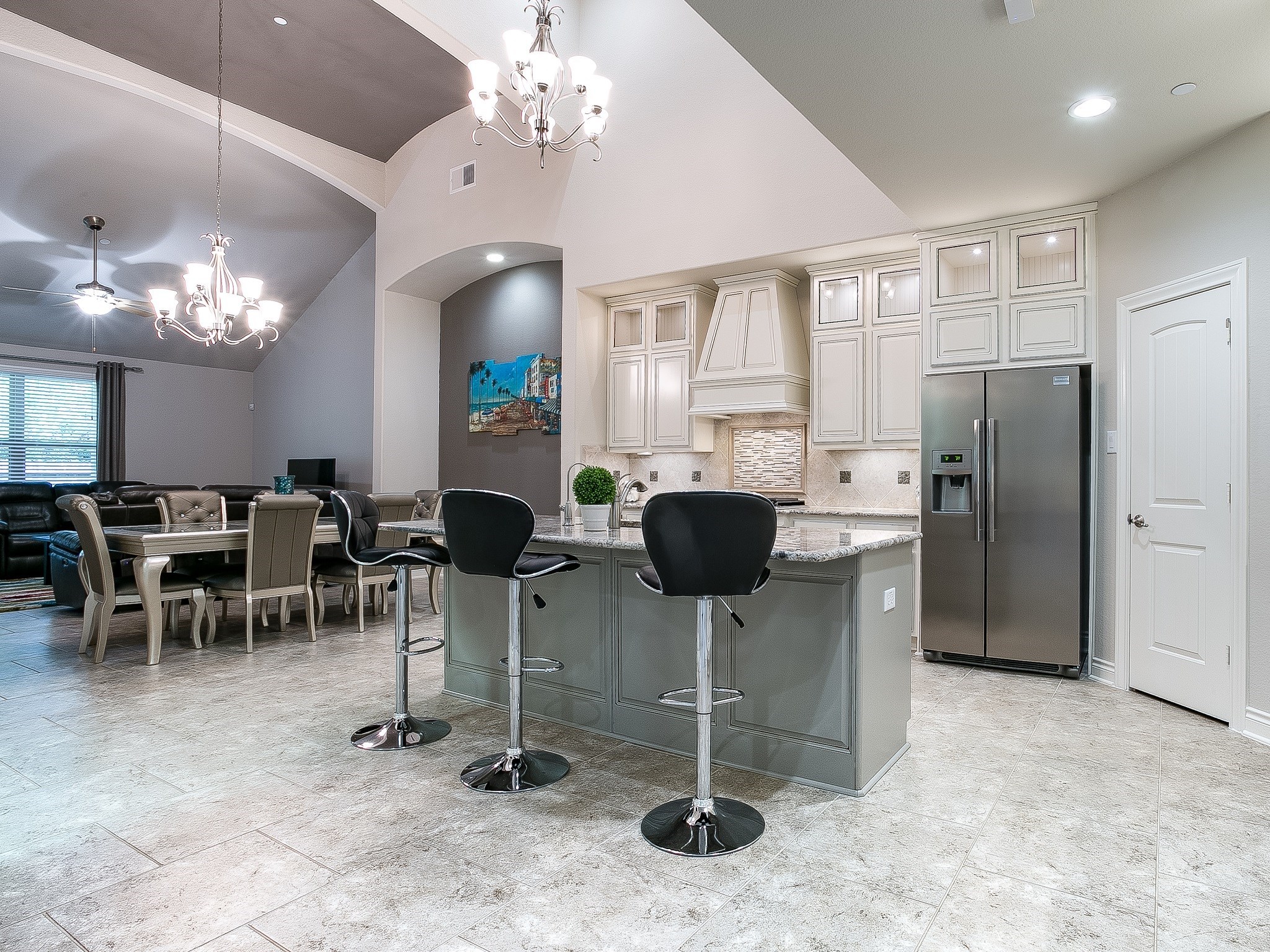 9018 Meacom Drive Conroe, TX 77384 - Photo 13 of 41 a kitchen with stainless steel appliances kitchen island granite countertop furniture a refrigerator a stove a dining table and chairs