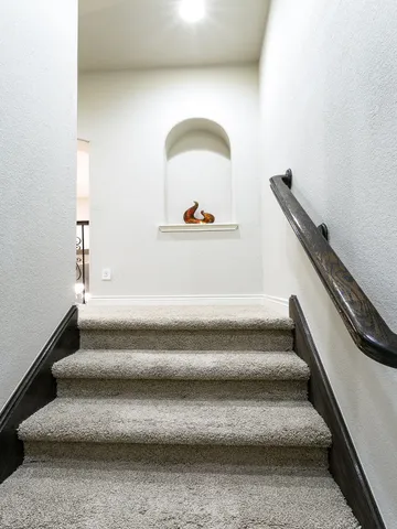 a view of a kitchen with refrigerator and a sink