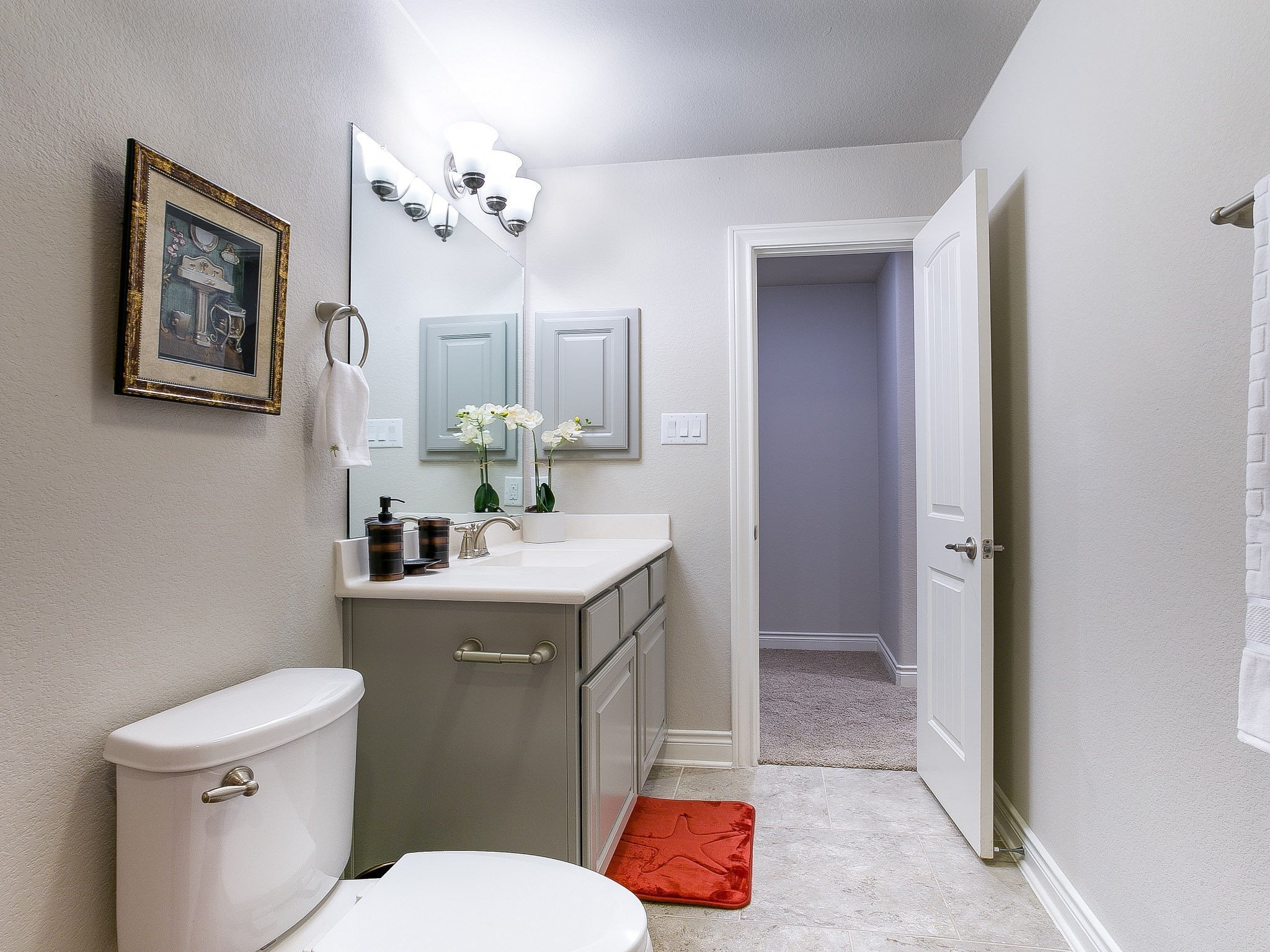 9018 Meacom Drive Conroe, TX 77384 - Photo 37 of 41 a bathroom with a granite countertop toilet sink and mirror