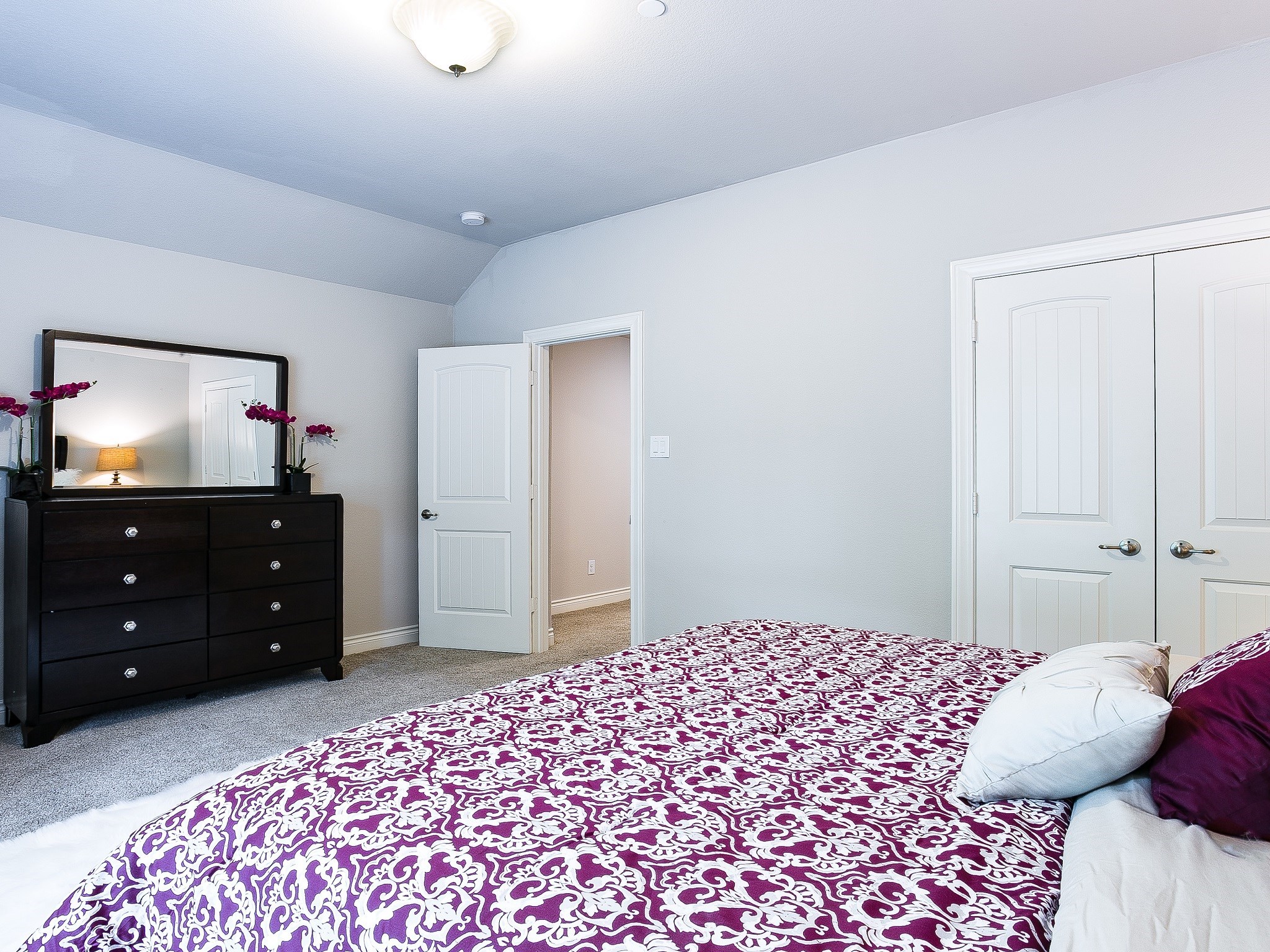 9018 Meacom Drive Conroe, TX 77384 - Photo 38 of 41 a bedroom with a bed and a flat tv screen on dresser